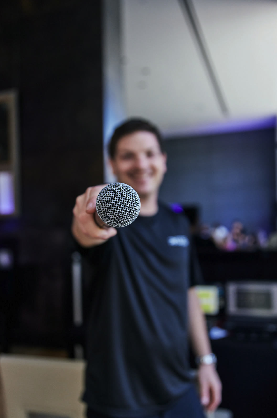A teammate offering the microphone
