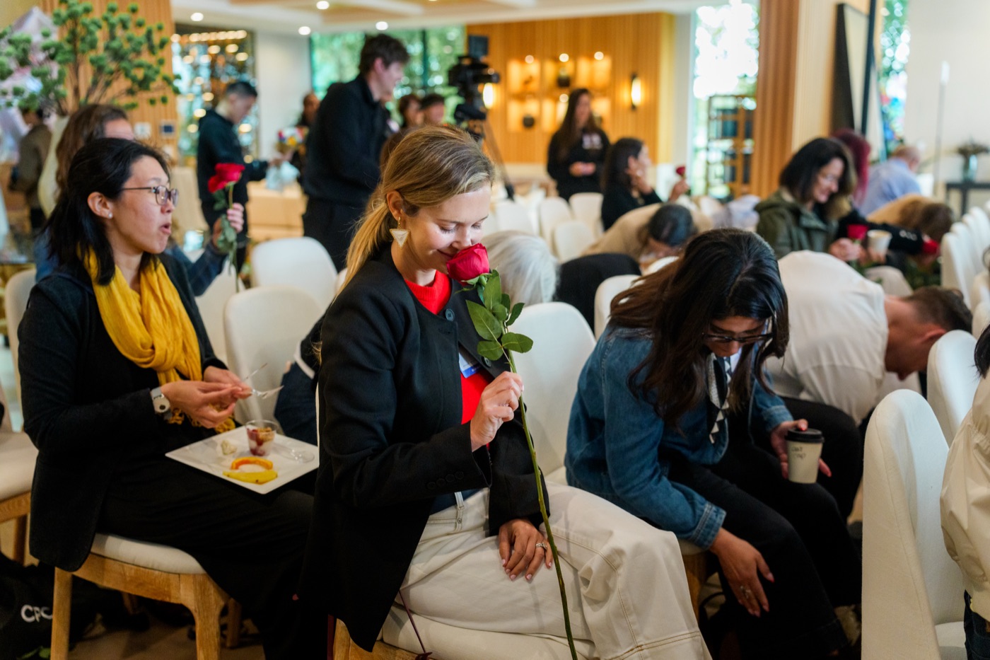 A guest pausing with a rose at Summit