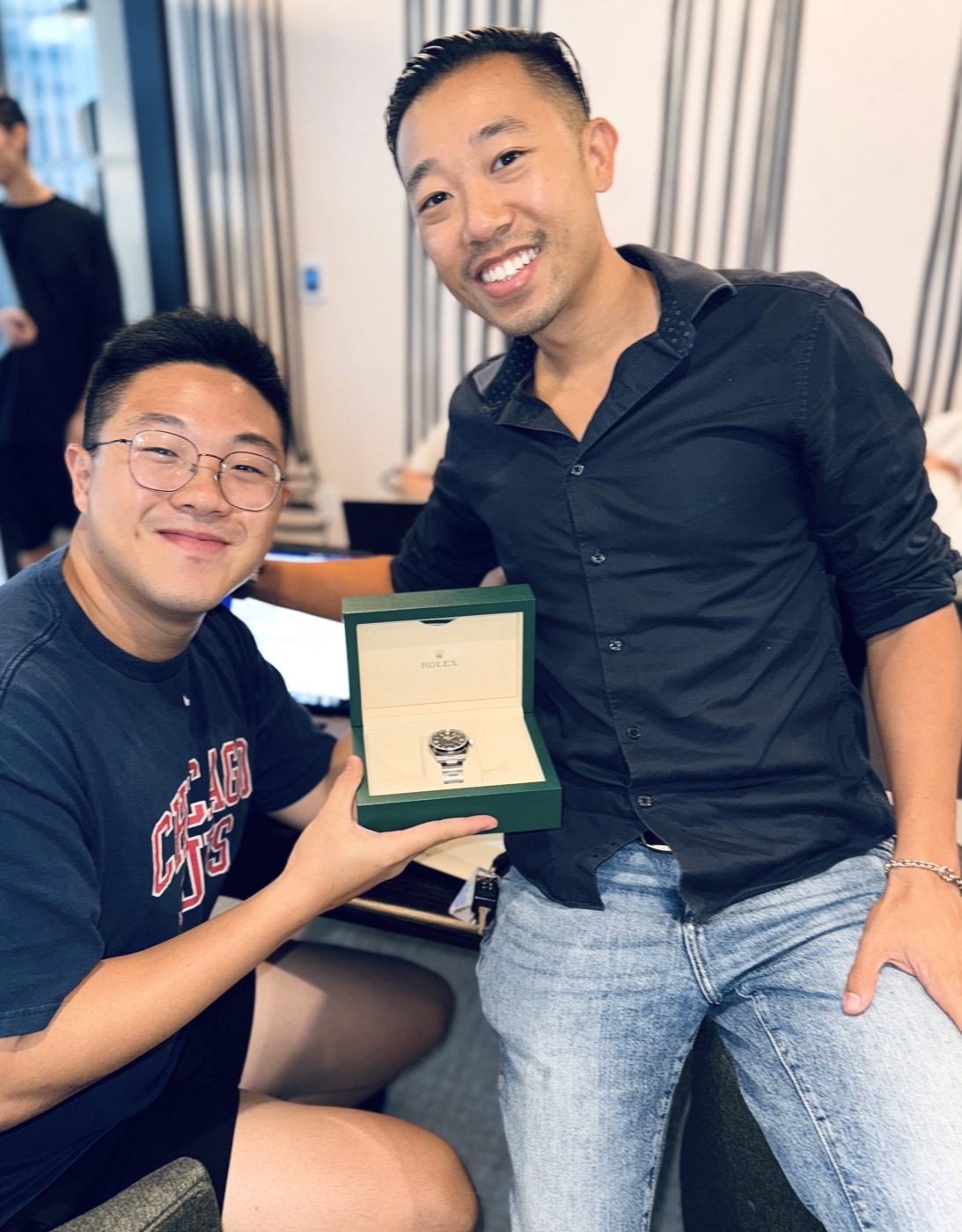 A teammate receiving a Rolex in the office